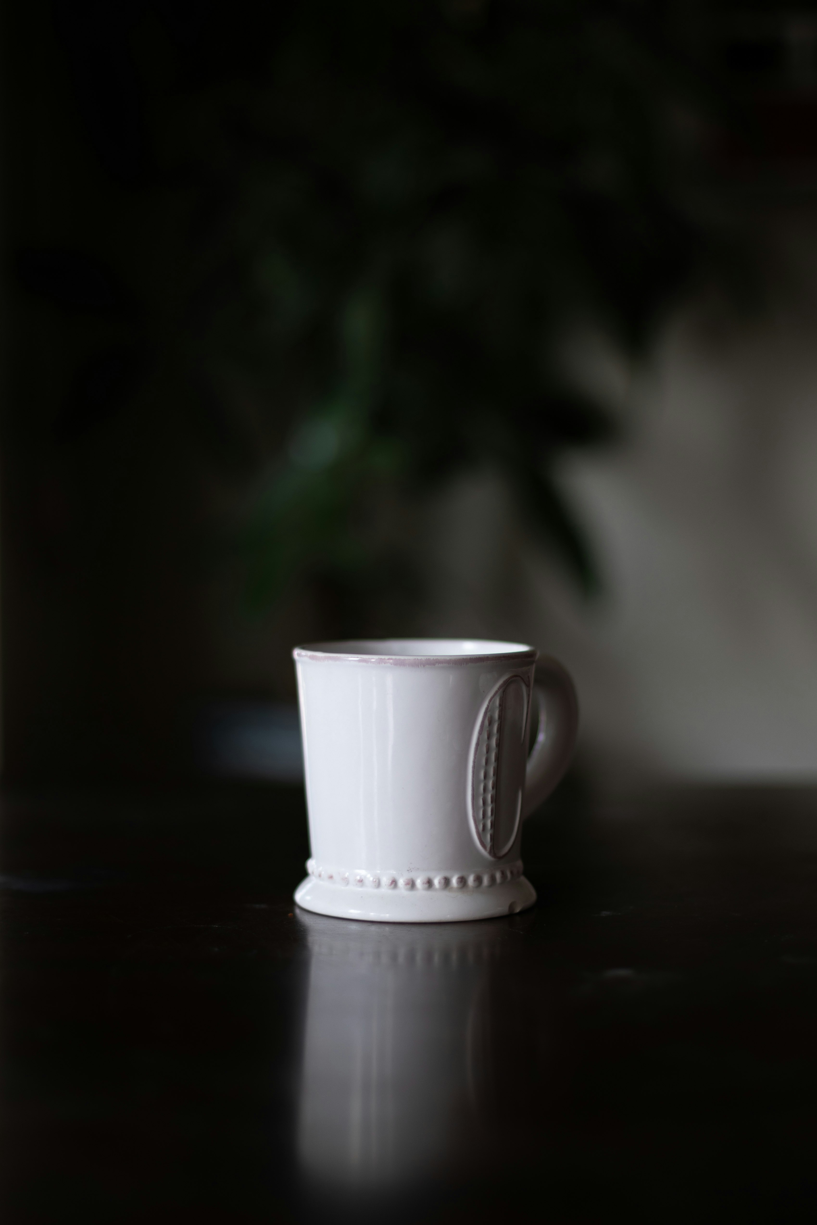white ceramic mug on black table